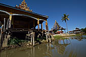 Inle Lake Myanmar. All the buildings are constructed on piles. Residents travel around by canoe, but there are also bamboo walkways and bridges over the canals, monasteries and stupas. 